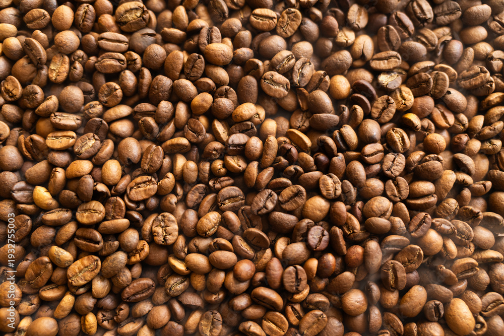 Fototapeta premium Close-up overhead view of roasted coffee beans, showcasing their rich brown color and texture