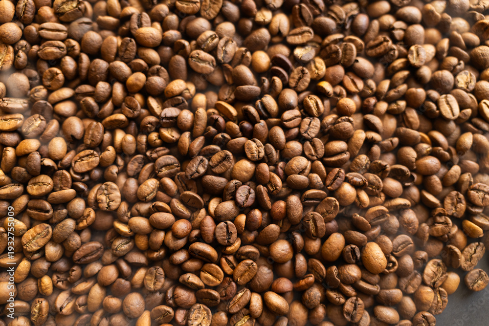 Fototapeta premium Close-up macro shot of roasted coffee beans, showcasing their rich texture and warm brown tones