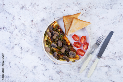 Omelette with mushrooms and green beans served with toast and cherry tomatoes