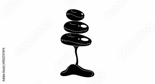 Stack of smooth black stones balancing precariously, representing harmony and zen.