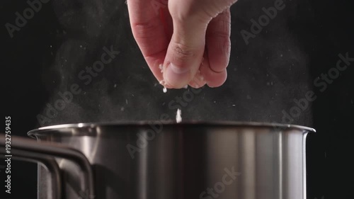 Wallpaper Mural Slow motion man salting boiling water in saucepan Torontodigital.ca