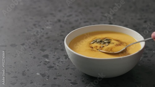 Wallpaper Mural Slow motion man eating pumpkin cream soup in white bowl on terrazzo countertop Torontodigital.ca
