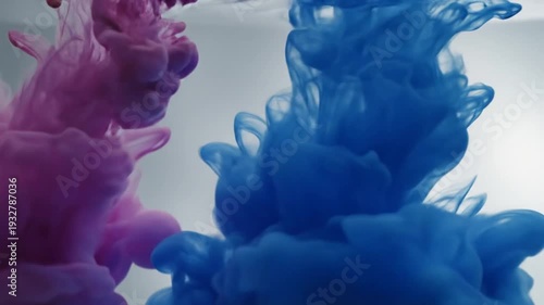 Dark blue ink dissolving in clear water creating abstract forms