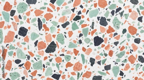 A colorful terrazzo pattern with orange, green, and black stones