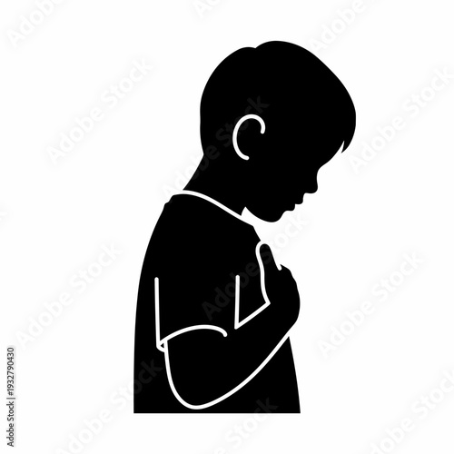 Silhouette of a young boy praying.