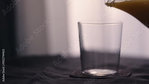 Wallpaper Mural Slow motion man pour orange mango juice in tumbler glass on linen cloth Torontodigital.ca