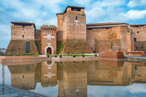 Slika na platnu Brick towers and defensive walls of Castel Sismondo in Rimini rise behind shallow reflecting pool, Emilia Romagna, Italy