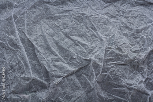 Wrinkled thin tissue paper texture background, crumpled translucent sheet with soft folds