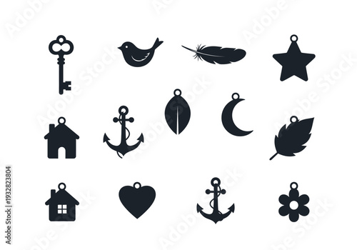 Collection of black silhouetted pendants featuring various symbols and objects arranged in a grid pattern on a plain white background viewed from directly above