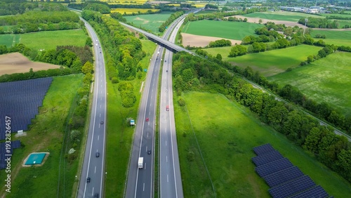Elevated view showing highway interchange, green fields, and solar panels in Schleswig Holstein