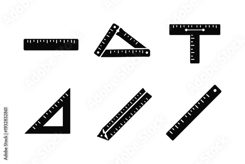 Collection of black measuring tools and rulers on a white background