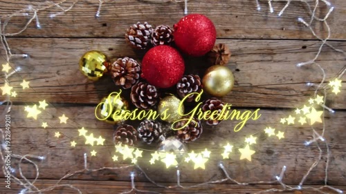 Animation of text, season's greetings, in yellow, over star string lights and christmas decorations