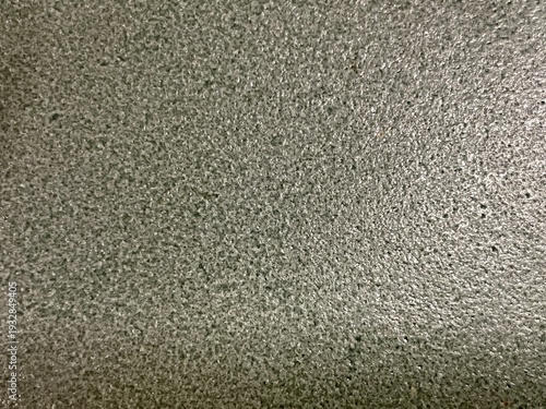 Abstract background. Grey textured stone surface with a grain finish and subtle highlights