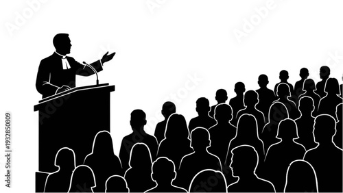 A man stands at a podium addressing a crowded audience from a raised platform in a conference hall