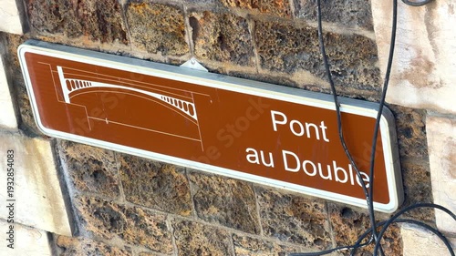 Pont au Double sign on the famous bridge near Notre Dame de Paris cathedral
