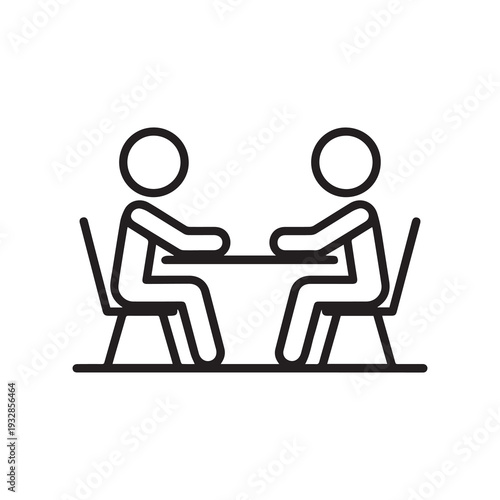 Two figures sitting face to face in minimalist chairs engaged in conversation at a small table in a clean modern setting