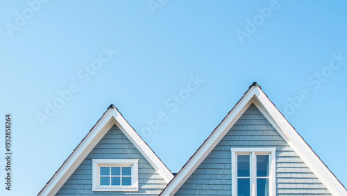 Blue house gable roof white window modern architecture residential building clear sky exterior minimal style peaceful daylight
