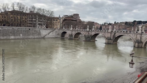 the iconic Tiber River that flows through the bridges of the city of Rome
