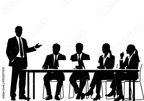 Business meeting with people sitting at a table and one standing