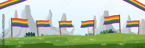 Row of rainbow pride flags on mountain landscape for outdoor pride event