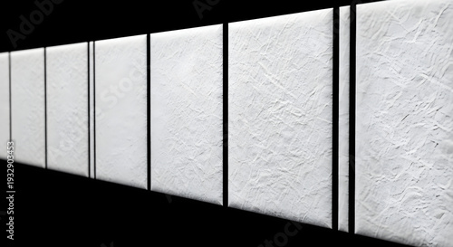 White textured panels with illuminated edges arranged in a row on black background studio