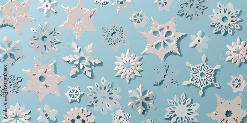 Paper snowflakes scattered on a light blue background create a winter scene