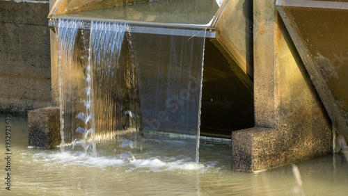 FlumeGate Irrigation water flow regulator and control gates that are remotely controlled and solar powered on a man made channel.	