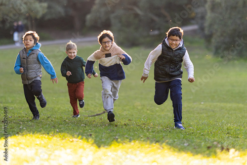 Photography Four happy boys running playing in park