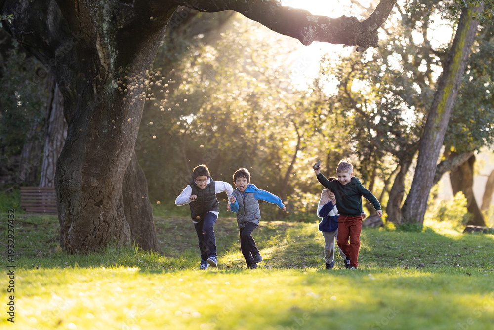 Fototapeta premium Happy children running and playing together in park