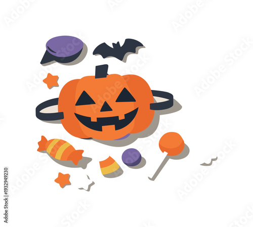 Minimal halloween party prep concept with pumpkin mask and candy loosely arranged seen from a top-down angle, offset to the left