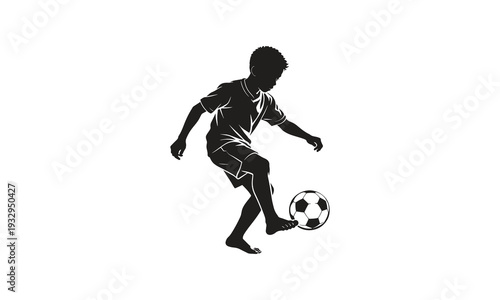 Silhouette of a Young Boy Playing Soccer Barefoot - Youth Street Football Concept