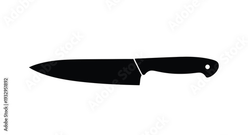 A stark black silhouette of a chef s knife lies against a white background emphasizing its sharp form silhouette