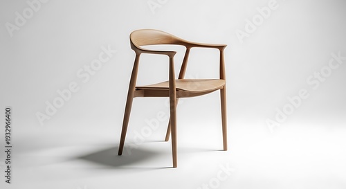 Elegant wooden armchair on a white backdrop, casting a shadow, with an organic, sleek design