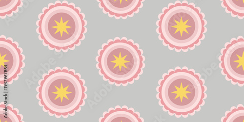 A pattern of pink and yellow floral designs on a gray background viewed from directly above