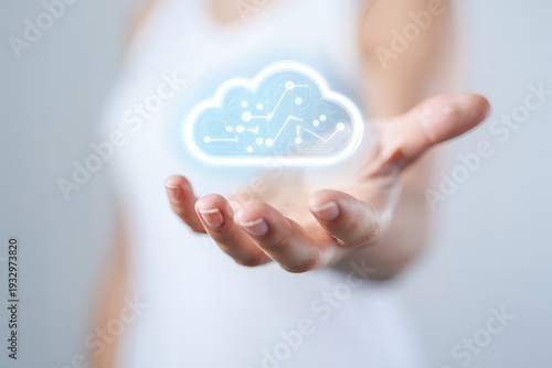 A person holds a glowing cloud icon with a line graph and dots in their hand in a conceptual representation of data storage and technology