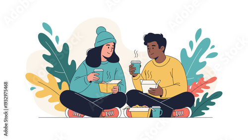 Multi-ethnic young couple sitting comfortably on the ground while enjoying takeout food boxes and hot coffee during a casual picnic.
