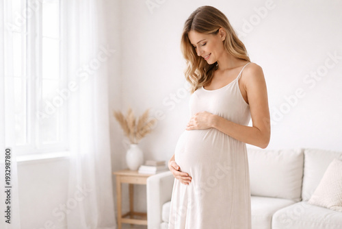 A pregnant woman hugs her belly with care and love. The image is in pastel beige tones.