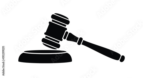 A striking black silhouette depicts a traditional gavel resting on a sound block symbolizing justice and legal authority silhouette
