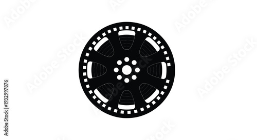 A striking black and white depiction of a vintage film reel with sprocket holes presented as a silhouette