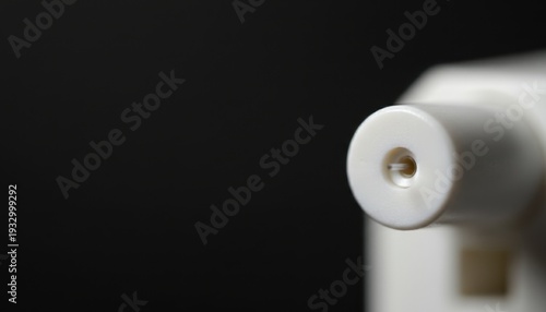 Close-up detail of a scientific microscope lens and eyepiece on a dark background