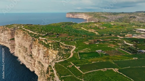 Drone view of Sanap Cliffs on Gozo island, part of Malta. Green fields, rocks and cliffs, sea
