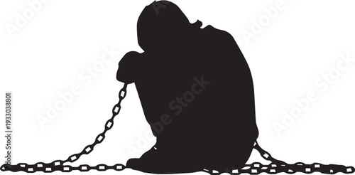 Silhouette of a person kneeling in contemplation with chains