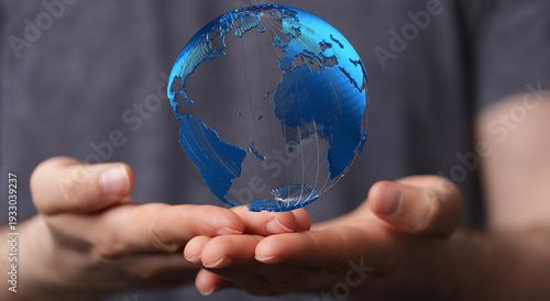Foto Person holding a digital earth, representing global connection, technology, and the future
