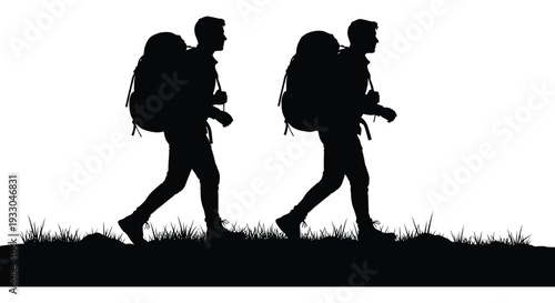 Two silhouetted hikers walk through grassy terrain with large backpacks