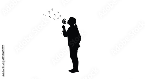 Child blowing dandelion seeds into the wind a striking silhouette