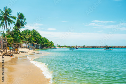 Photography Tropical beach with palm trees turquoise water sea and fishing boats on Phu Quoc island, Vietnam