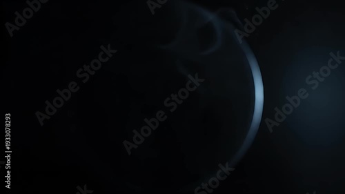 Abstract smoke swirling against a dark background, artistic visual.