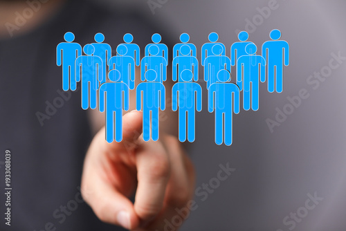 Hand pointing at a group of...