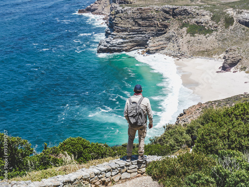 фотографія Man with backpack standing at Cape of Good Hope, South Africa