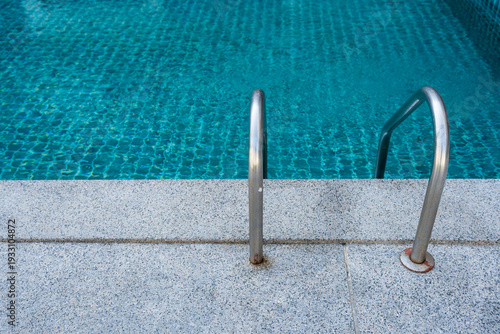 Wallpaper Mural Swimming pool with stainless steel ladder stair and blue water Torontodigital.ca